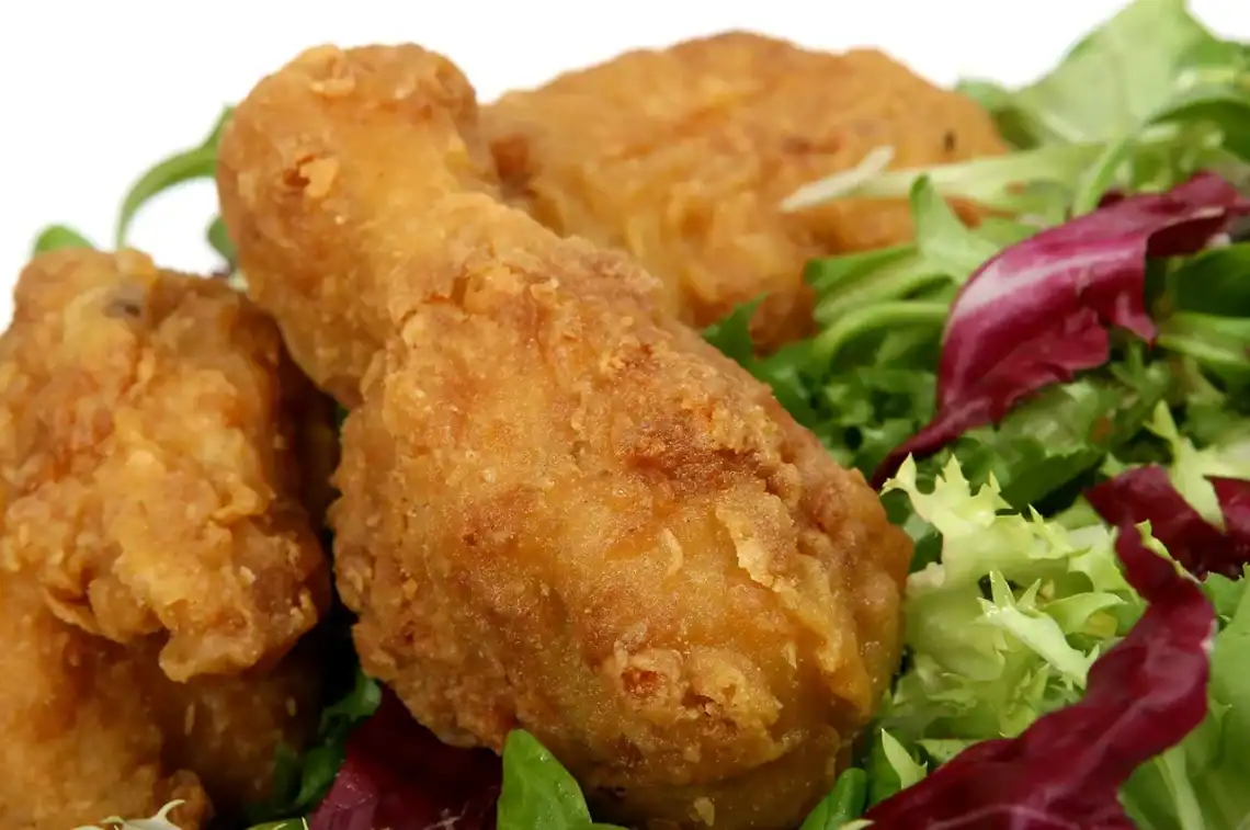 Secret Recipe Fried Chicken - Saffarazzi Golden fried chicken pieces served on mixed greens and lettuce.