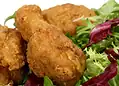Secret Recipe Fried Chicken - Saffarazzi Golden fried chicken pieces served on mixed greens and lettuce.