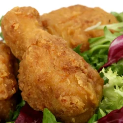 Secret Recipe Fried Chicken - Saffarazzi Golden fried chicken pieces served on mixed greens and lettuce.