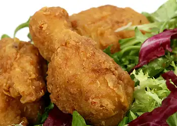 Secret Recipe Fried Chicken - Saffarazzi Golden fried chicken pieces served on mixed greens and lettuce.