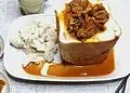South African Lamb Curry Bunny Chow - Saffarazzi South African lamb curry bunny chow served in a hollowed white loaf