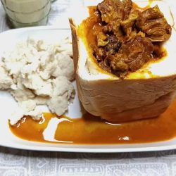 South African Lamb Curry Bunny Chow - Saffarazzi South African lamb curry bunny chow served in a hollowed white loaf