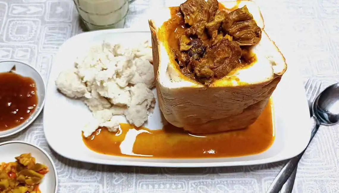 South African Lamb Curry Bunny Chow - Saffarazzi South African lamb curry bunny chow served in a hollowed white loaf