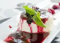 Buttermilk panna cotta served with spiced plums and citrus sauce