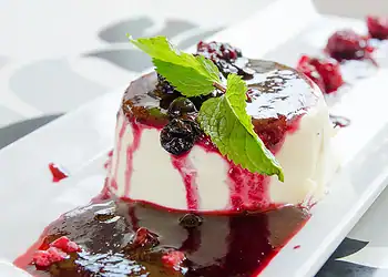 Buttermilk panna cotta served with spiced plums and citrus sauce