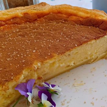 Baked Milk tart, a traditional South African dessert, is a smooth and creamy custard filling baked in a sweet pastry crust.