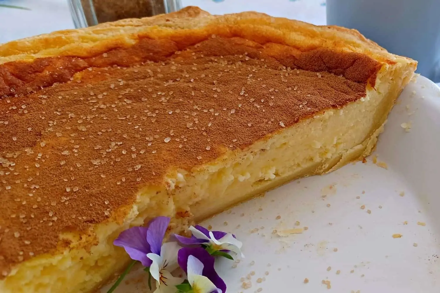 Baked Milk tart, a traditional South African dessert, is a smooth and creamy custard filling baked in a sweet pastry crust.