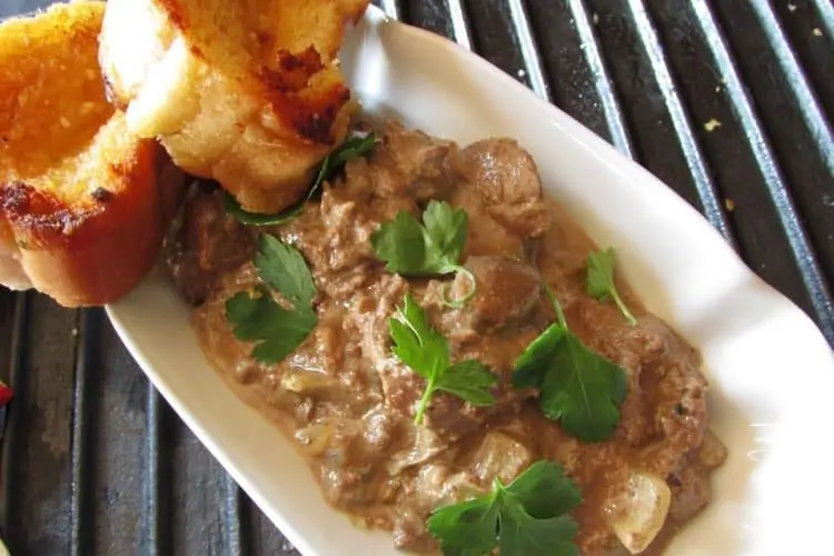 Chicken Livers Fried in Creamy Garlic Sauce and Served with Bread