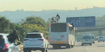 Bus surfers dance on top of a moving bus on the N3 freeway in Durban.