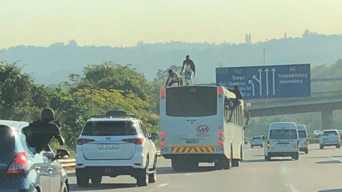 Bus surfers dance on top of a moving bus on the N3 freeway in Durban.