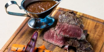 The perfect steak has a beautiful brown crust on the outside while being red and tender on the inside.