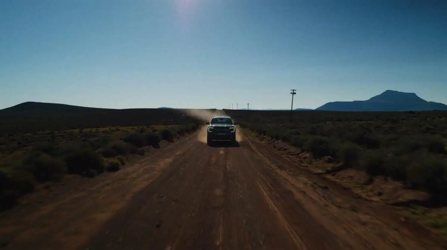 Ford bakkie approaching camera on a remote gravel road - Saffarazzi Ford bakkie approaching camera on a remote gravel road