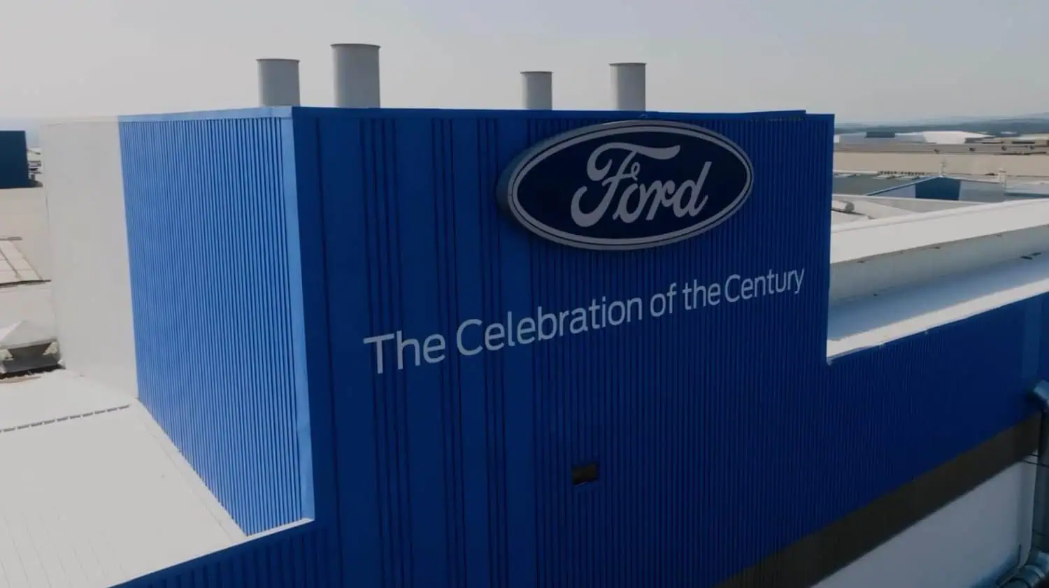 Ford Celebration of the Century signage on factory building - Saffarazzi Ford Celebration of the Century signage on factory building
