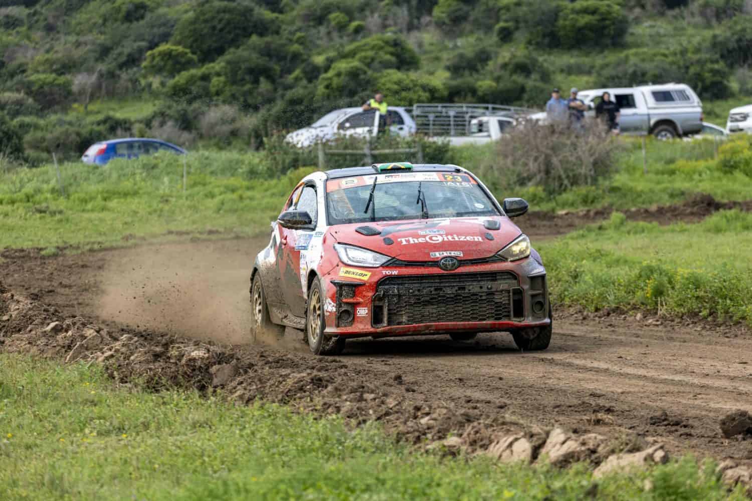 Toyota GR Yaris rally car passing spectators on gravel stage - Saffarazzi Toyota GR Yaris rally car passing spectators on gravel stage