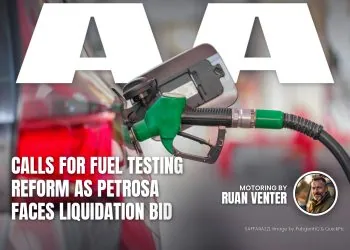 Green fuel nozzle refuelling a car at a filling station