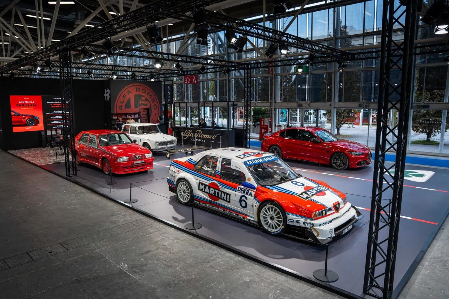 Alfa Romeo Classiche exhibition stand - Saffarazzi Alfa Romeo stand with 155 touring car and Giulias.