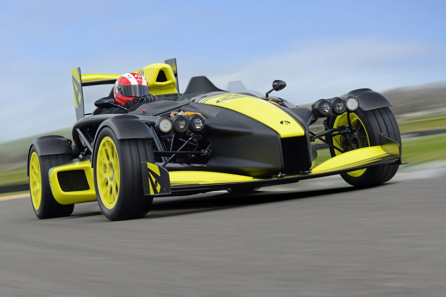 Ariel Atom on circuit - Saffarazzi Ariel Atom with yellow wheels on race track.