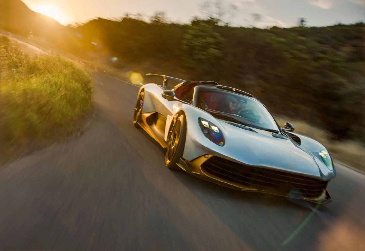Valhalla Spider cornering at dusk - Saffarazzi Aston Martin Valhalla Spider cornering on a road at dusk.