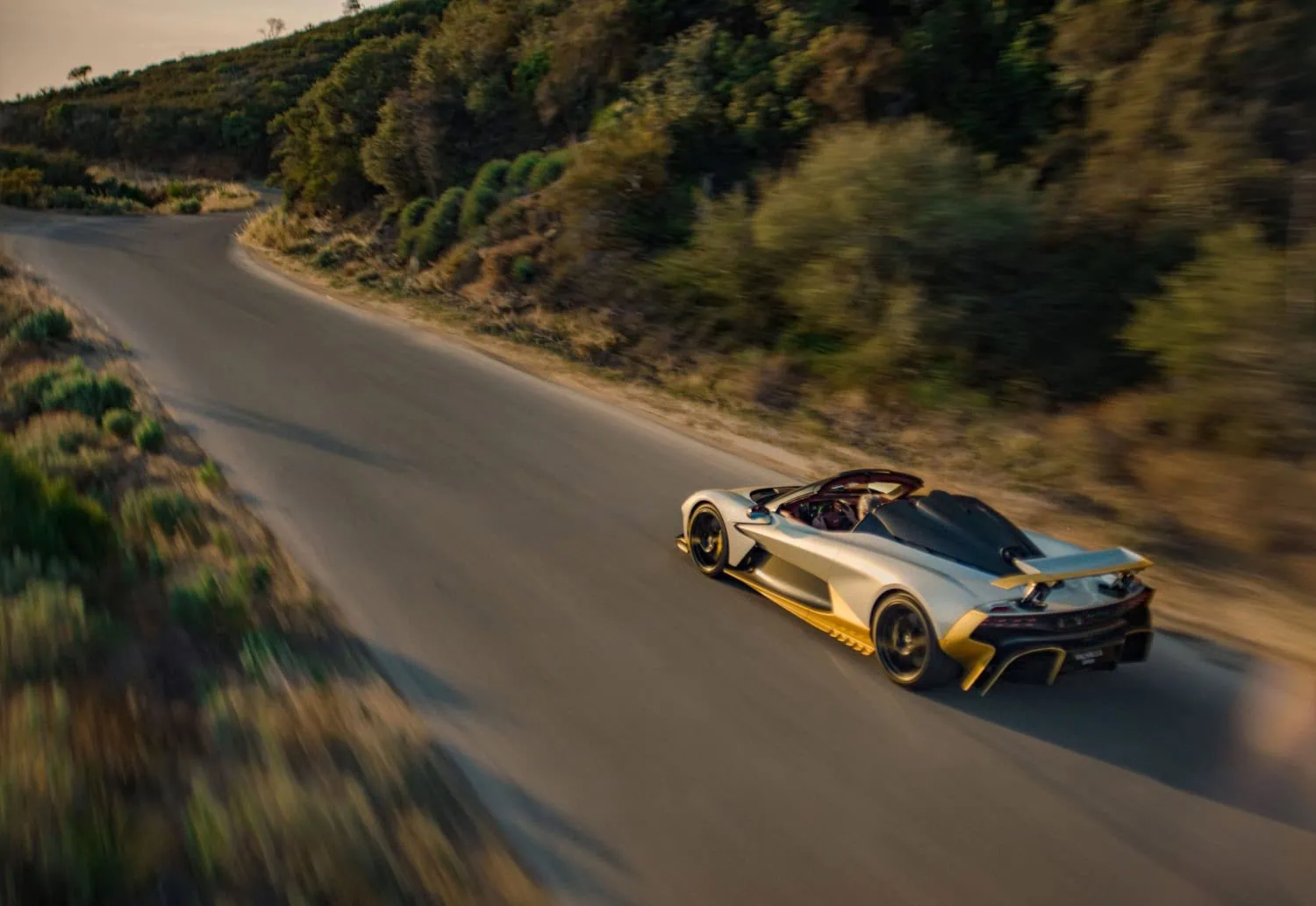 Valhalla Spider on winding road - Saffarazzi Aston Martin Valhalla Spider rear view on a winding road.