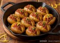Golden biltong-crusted roast potatoes with crisp scored edges, savoury biltong crumbs and fresh parsley