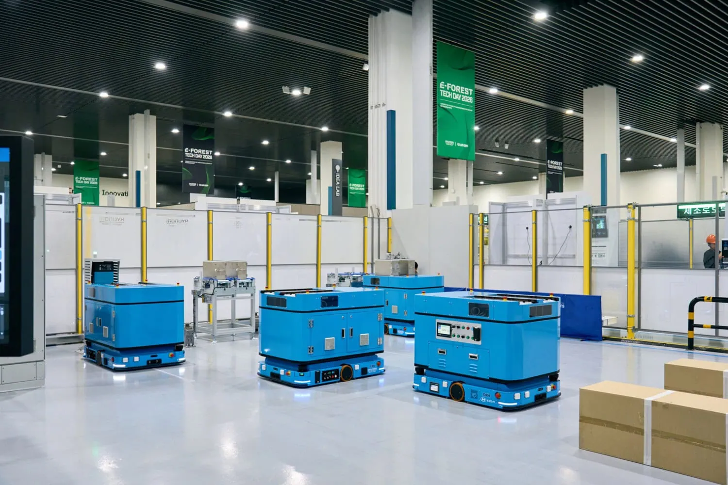 Autonomous mobile robots on floor - Saffarazzi Blue autonomous mobile robots at E-FOREST Tech Day 2026.