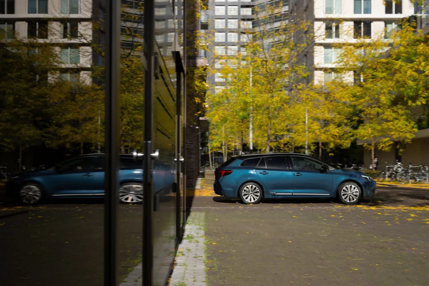 Corolla Touring Sports estate - Saffarazzi Blue Toyota Corolla Touring Sports reflected in glass.