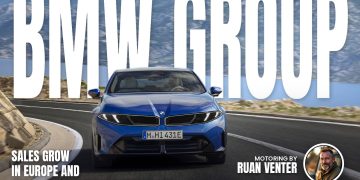 Blue BMW saloon front view on a coastal road