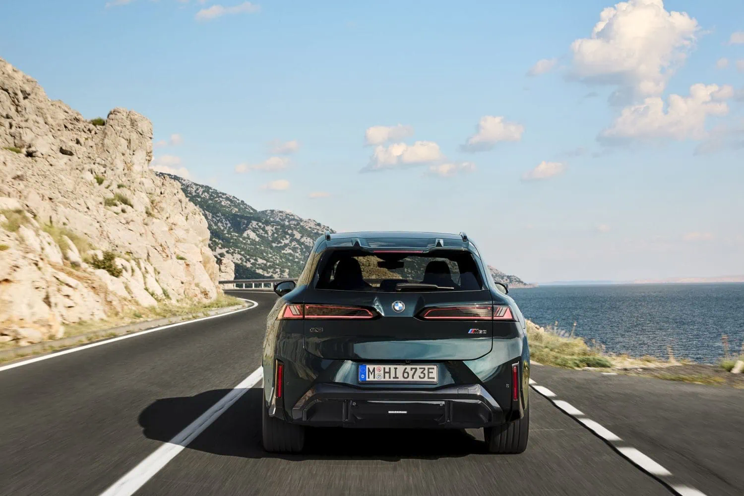 BMW iX3 M60 xDrive rear view on coastal road - Saffarazzi BMW iX3 M60 xDrive rear view on coastal road