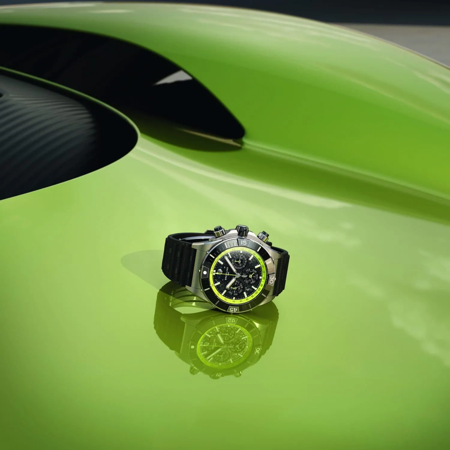Breitling Super Chronomat on lime green Aston Martin Valhalla bodywork - Saffarazzi Breitling Super Chronomat on lime green Aston Martin Valhalla bodywork