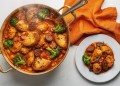 Quick Chicken, Sausage and Borlotti Bean Stew - Saffarazzi Hearty chicken stew with broccoli, beans, tomatoes and crusty bread in a copper pan, with an orange napkin nearby.