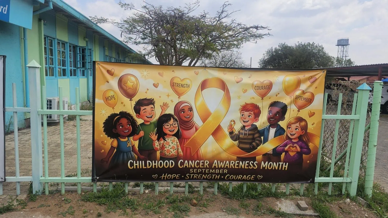 Childhood Cancer Awareness Month banner on hospital fence - Saffarazzi Childhood Cancer Awareness Month banner on hospital fence