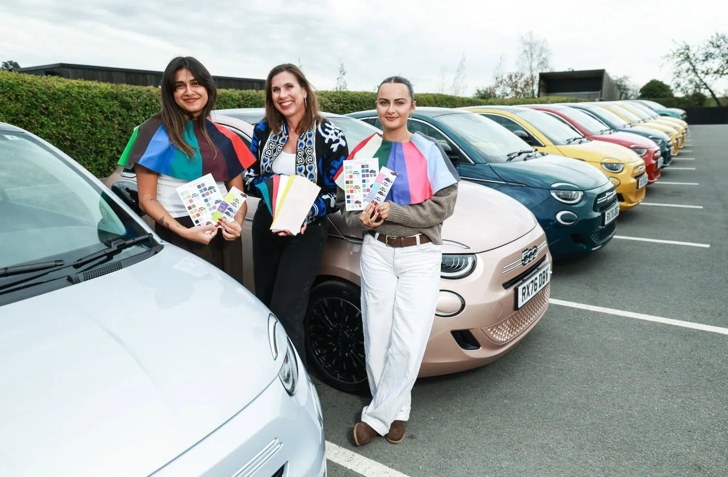 Consultants beside Fiat 500 row - Saffarazzi Consultants with swatch cards beside pink Fiat 500 Hybrid.