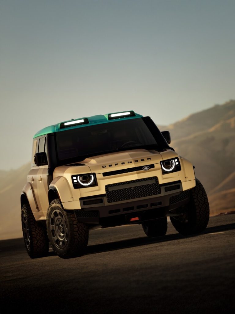 Defender with roof lights on mountain road, front view - Saffarazzi Defender with roof lights on mountain road, front view