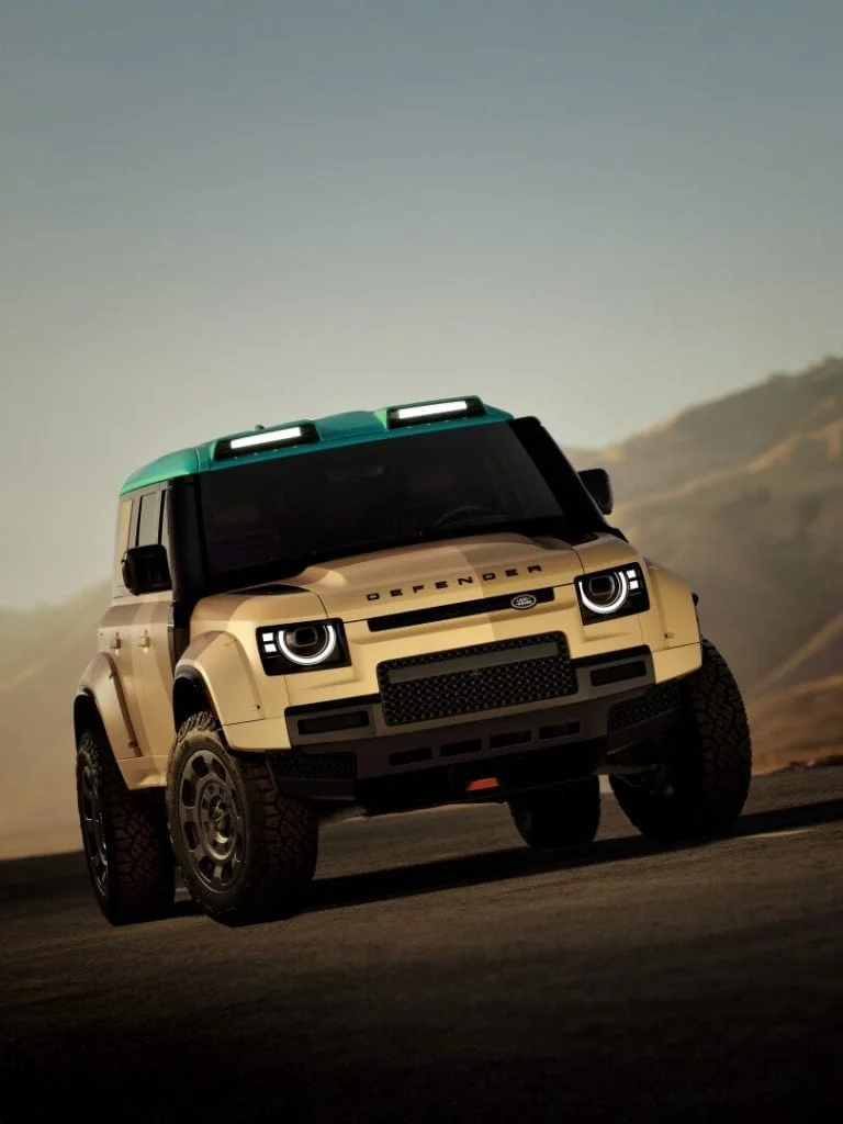 Defender with roof lights on mountain road, front view - Saffarazzi Defender with roof lights on mountain road, front view