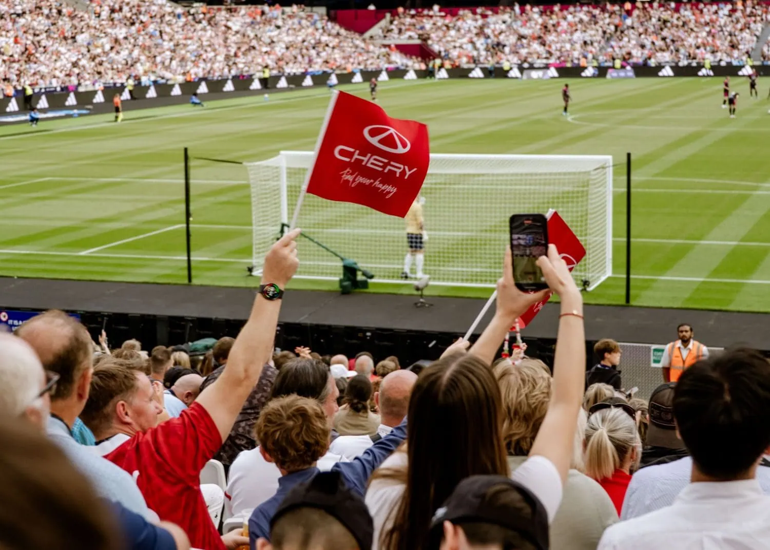 Fans waving Chery flags at a football match - Saffarazzi Fans waving Chery flags at a football match