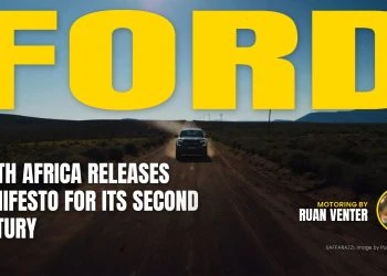 Ford bakkie driving on a dirt road through arid landscape