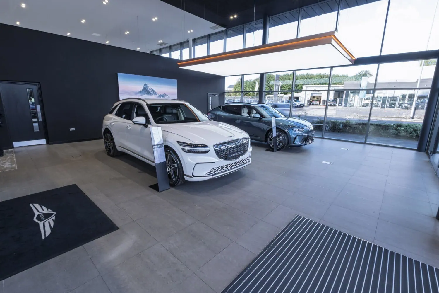 Genesis showroom with two cars - Saffarazzi Genesis GV70 and GV60 in Leeds showroom.