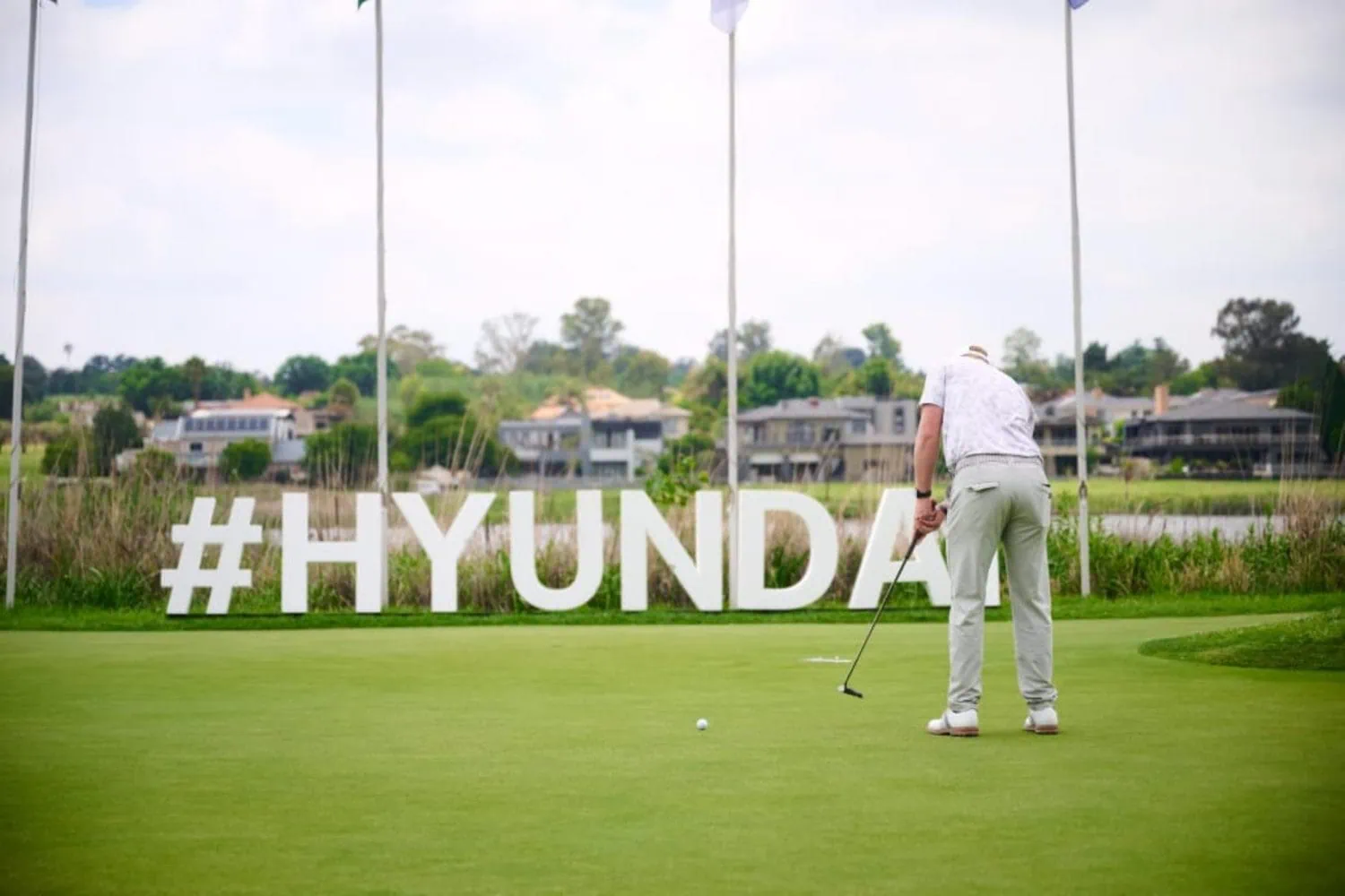 Golfer putting beside Hyundai hashtag letters at Ebotse - Saffarazzi Golfer putting beside Hyundai hashtag letters at Ebotse
