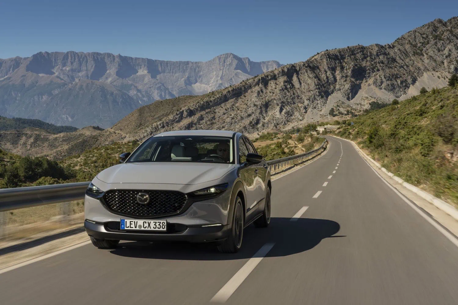 Grey Mazda CX-30 driving on a mountain road - Saffarazzi Grey Mazda CX-30 driving on a mountain road