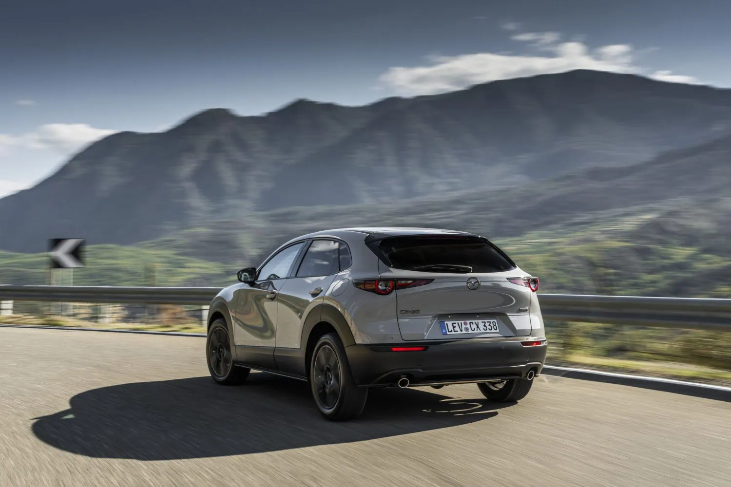 Grey Mazda CX-30 rear three-quarter view on the move - Saffarazzi Grey Mazda CX-30 rear three-quarter view on the move