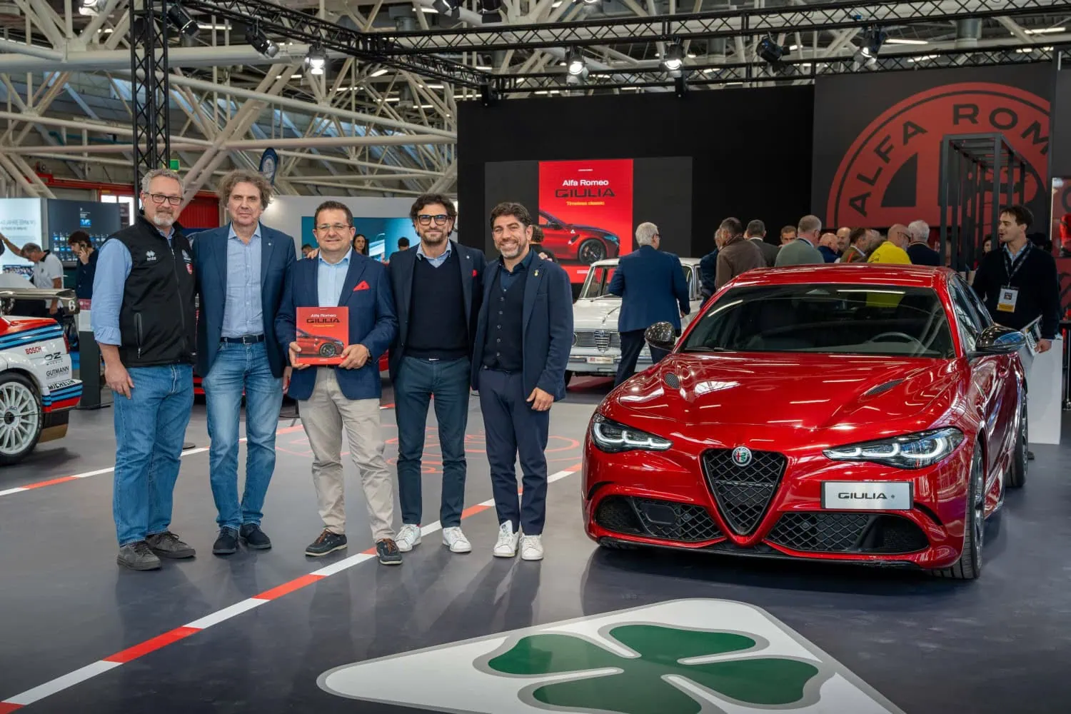 Book launch group with Giulia - Saffarazzi Group with Alfa Romeo Giulia book beside Giulia Quadrifoglio.