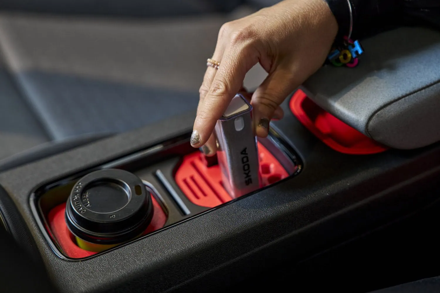 Key placed in insert - Saffarazzi Hand placing Škoda key into red 3D-printed insert.