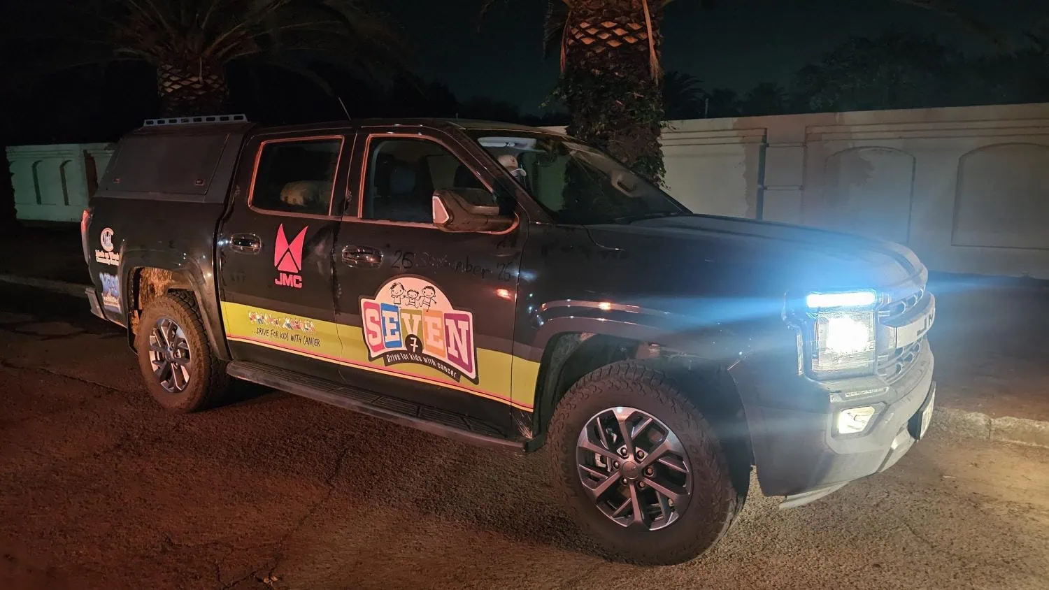 JMC pickup on Seven7 Drive with headlights on at night - Saffarazzi JMC pickup on Seven7 Drive with headlights on at night