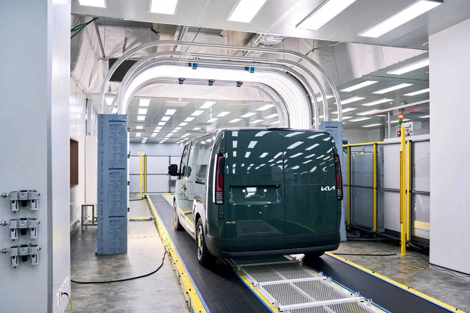 Kia PV5 in inspection tunnel - Saffarazzi Kia PV5 van passing through inspection tunnel.