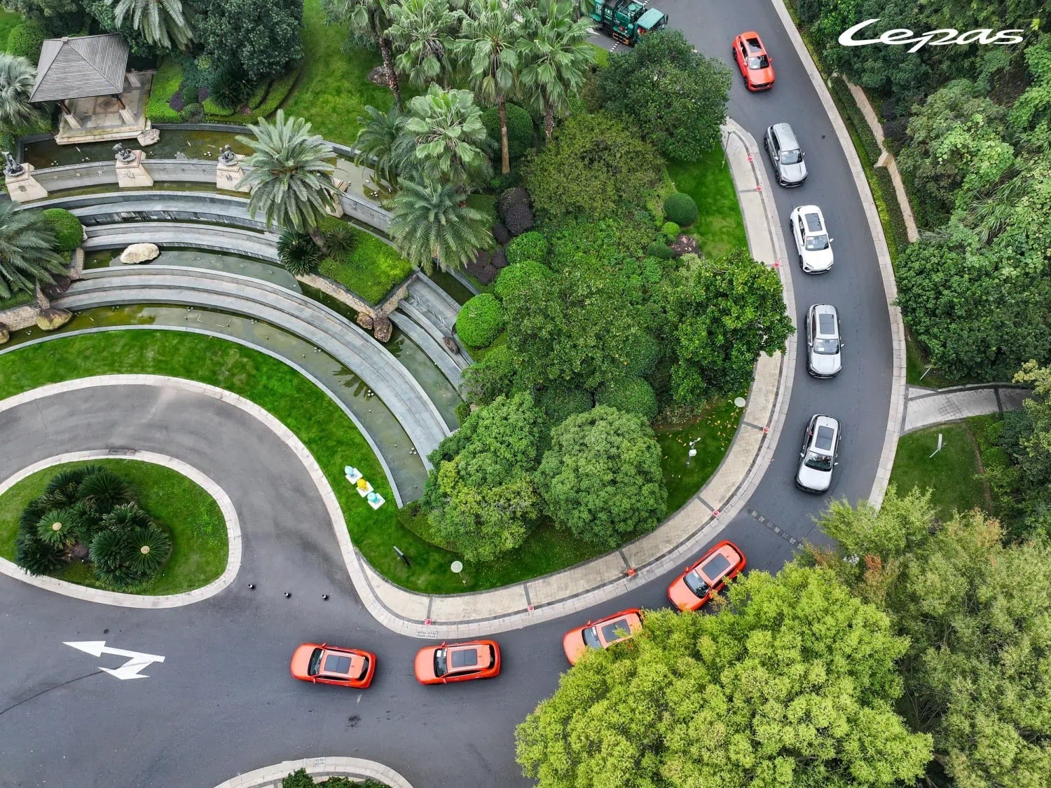 Lepas L6 EV convoy aerial - Saffarazzi Lepas L6 EV convoy on a winding road.
