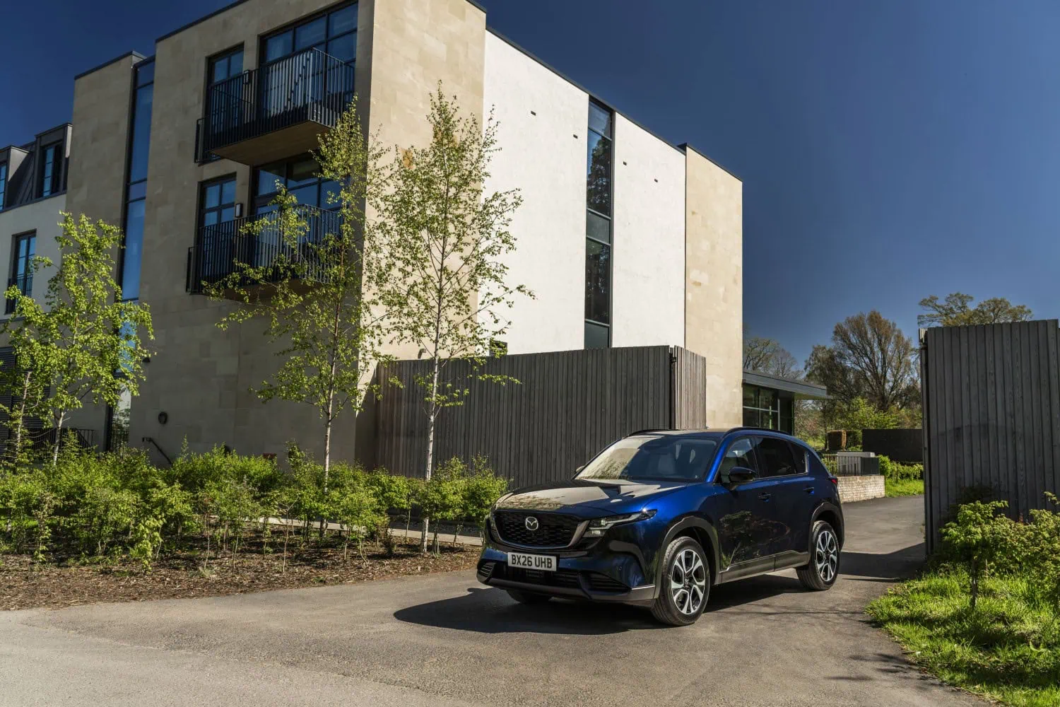 Mazda CX-5 by modern building - Saffarazzi Mazda CX-5 front view beside modern stone building.