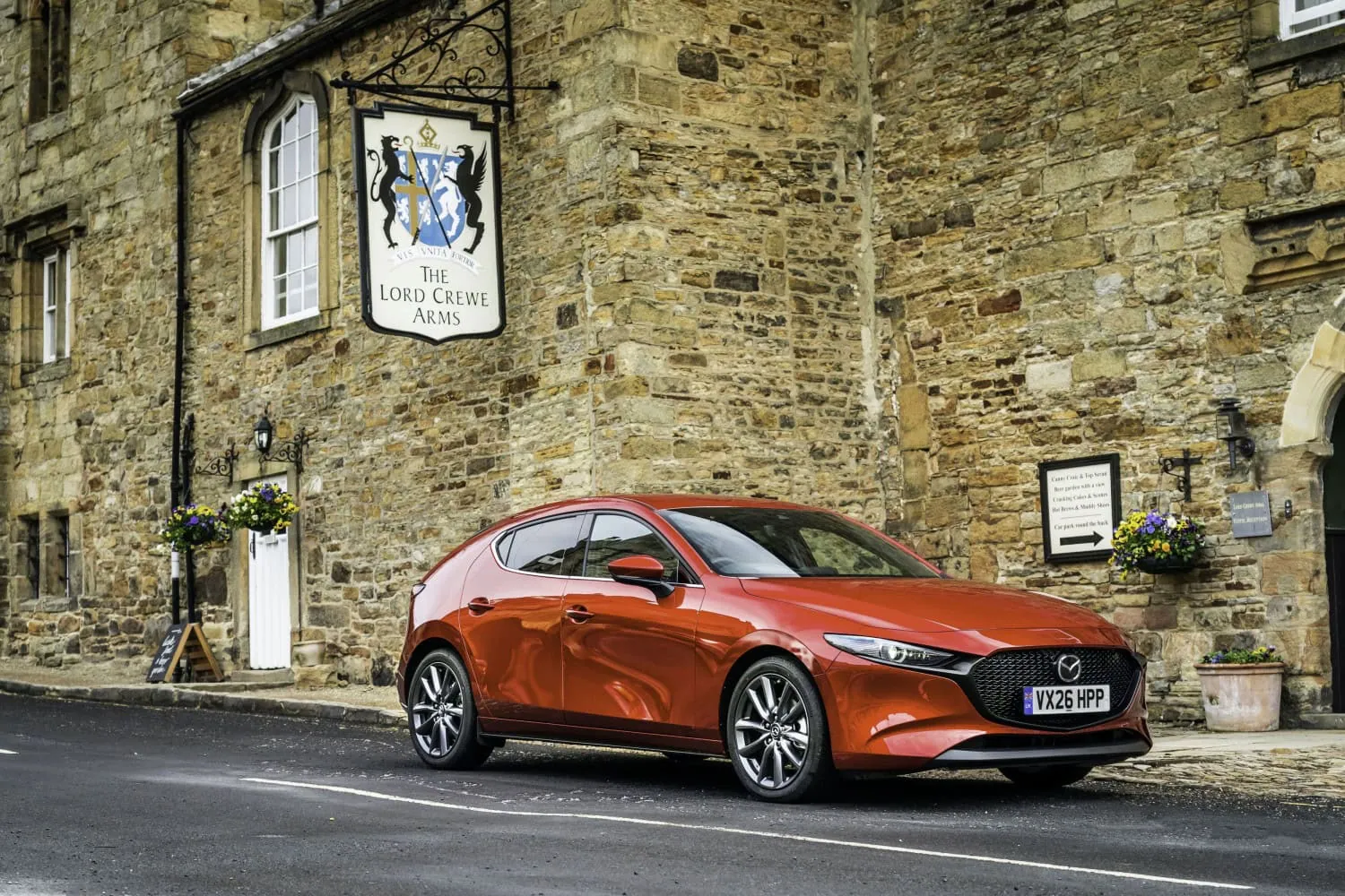 Red Mazda3 at village inn - Saffarazzi Mazda3 hatchback in red outside the Lord Crewe Arms.