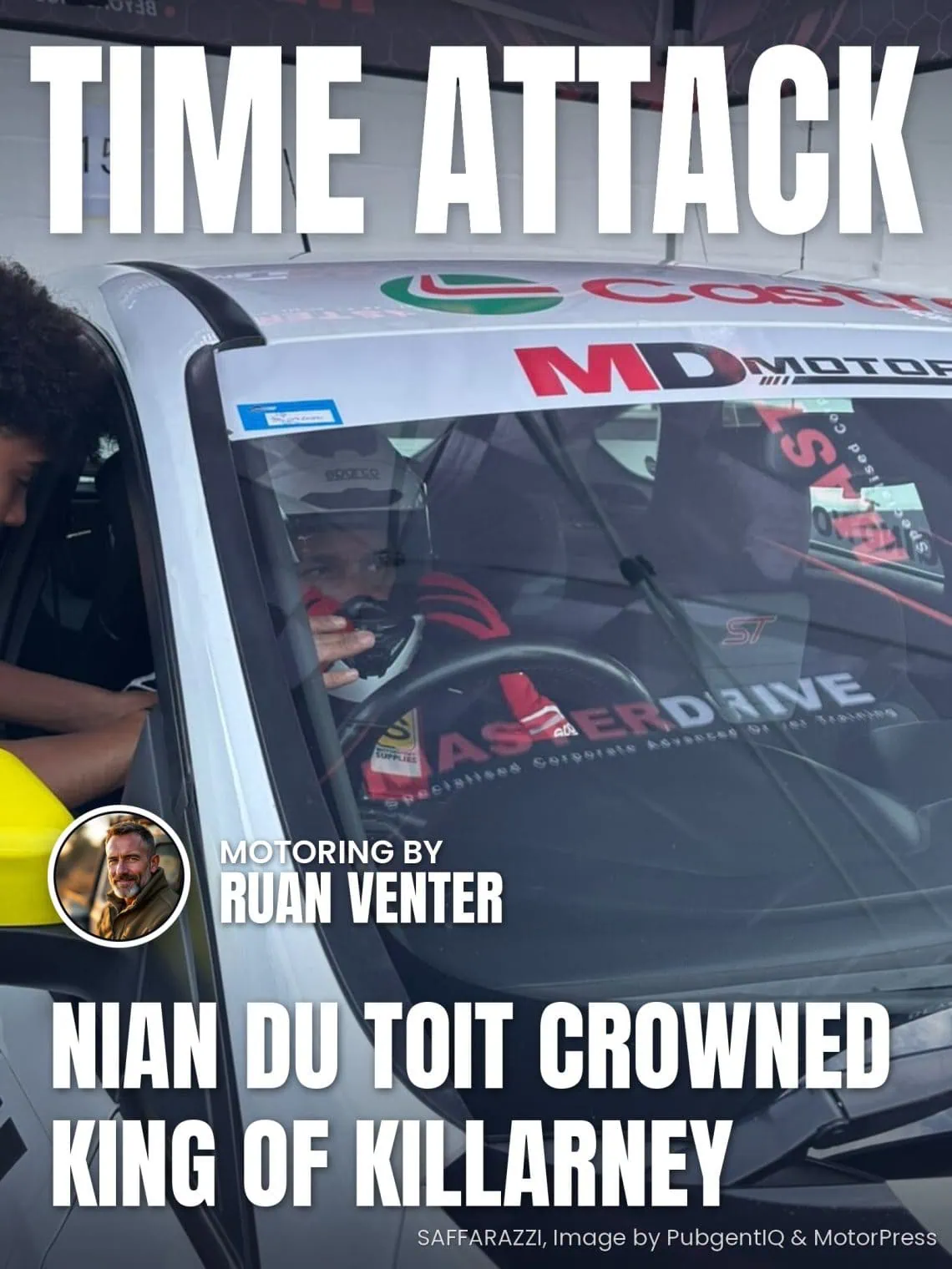 Driver seated in MasterDrive branded race car in pit garage