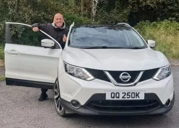 Nissan Qashqai crossover front view with owner at open door