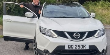 Nissan Qashqai crossover front view with owner at open door